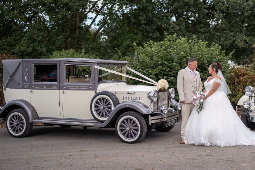 The bride and groom beside the ivory and silver Imperial Viscount, registration M14RRY.